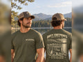 Male model wearing the Dirty Footprints Adventure Starts at the Waterline tee in military green, front and back