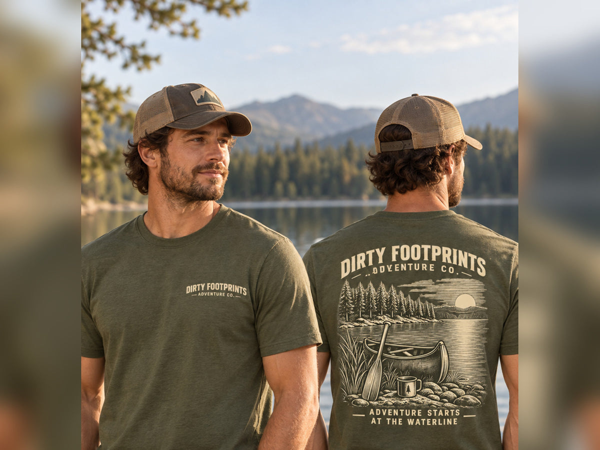 Male model wearing the Dirty Footprints Adventure Starts at the Waterline tee in military green, front and back